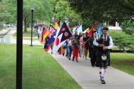 十大菠菜台子 kicks off the fall semester with a colorful parade that includes all the international flags of first-year students as they march down College Street to the convocation ceremonies at Eaton Chapel.